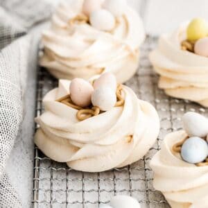 closeup of meringue nest filled with buttercream and cadbury eggs candy