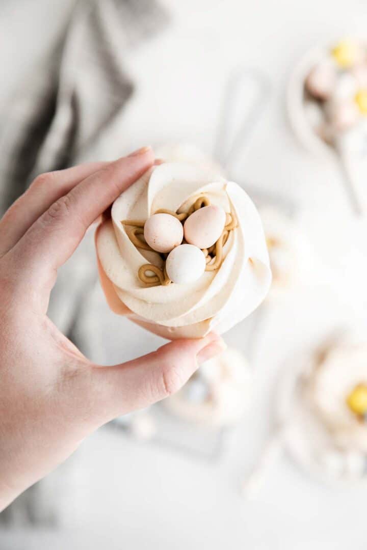 hand holding a meringue nest in fingers