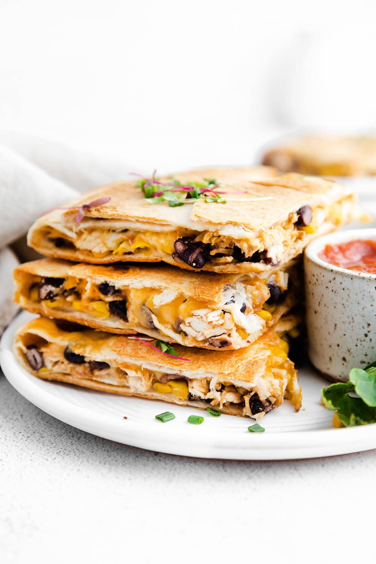stack of three quesadillas with chicken, cheese, and black beans
