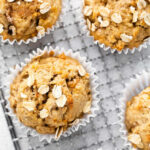 five banana carrot muffins on a wire cooling rack