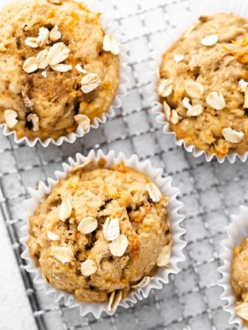 closeup of three banana carrot muffins with oats on top