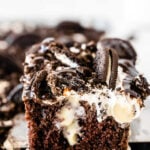 closeup of a slice of oreo cookie chocolate poke cake