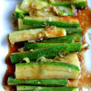 zucchini wedge slices topped with brown sauce and scallions
