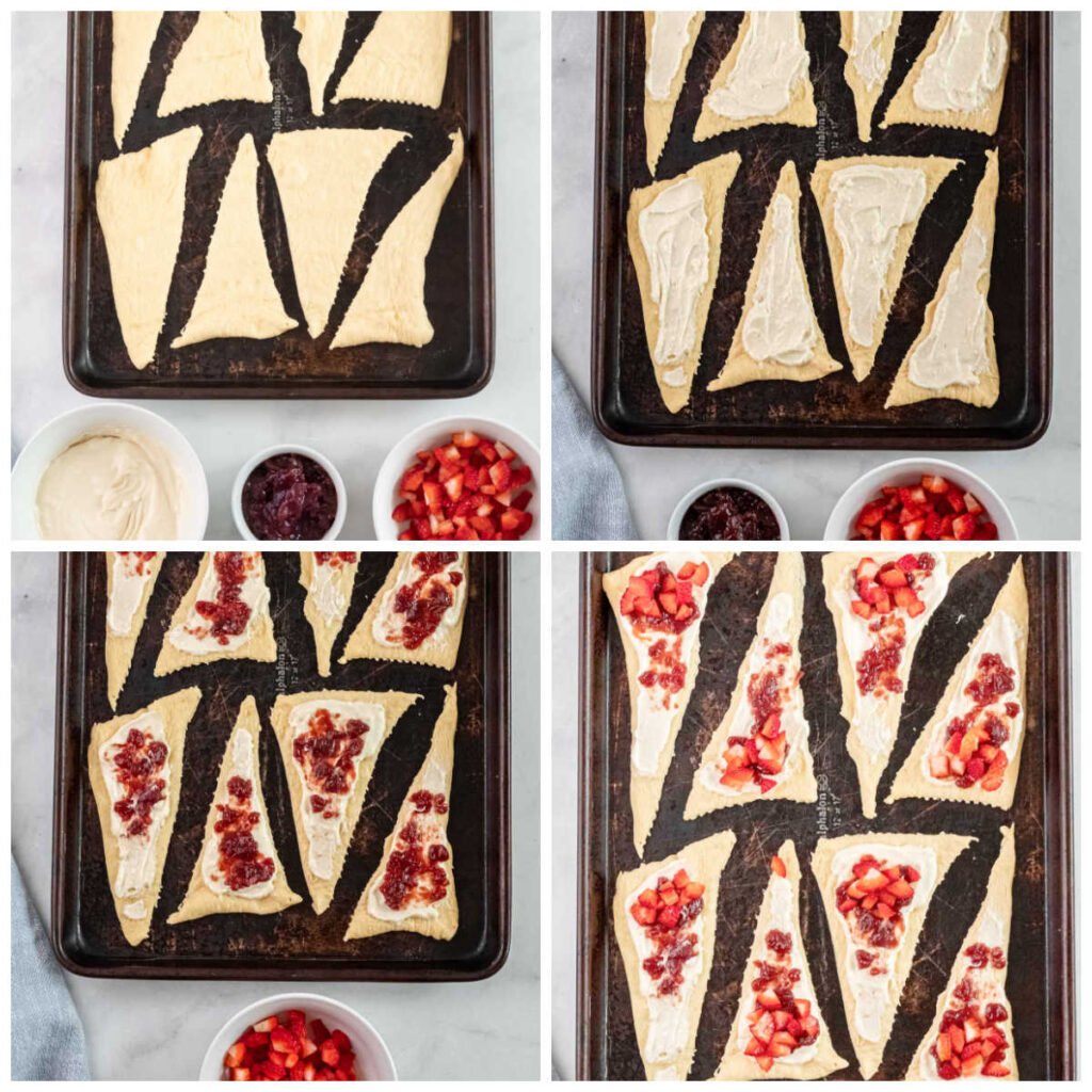 crescent roll dough on a baking sheet with cream cheese, jam and diced strawberries on top of each triangle