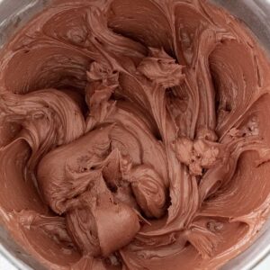 closeup of fluffy chocolate frosting in a mixing bowl