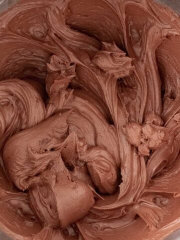 closeup of fluffy chocolate frosting in a mixing bowl