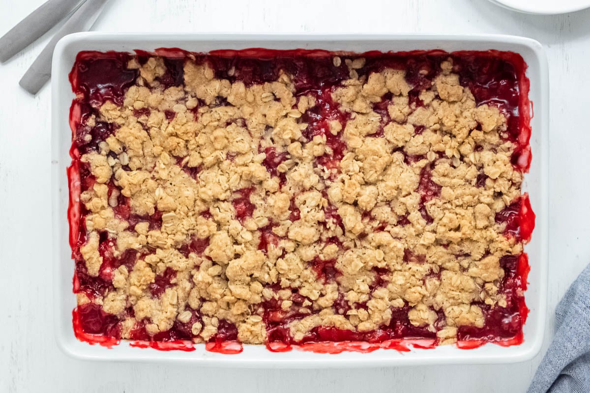 strawberry crumble in a white rectangle baking dish