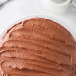 closeup of top of round chocolate cake on a white