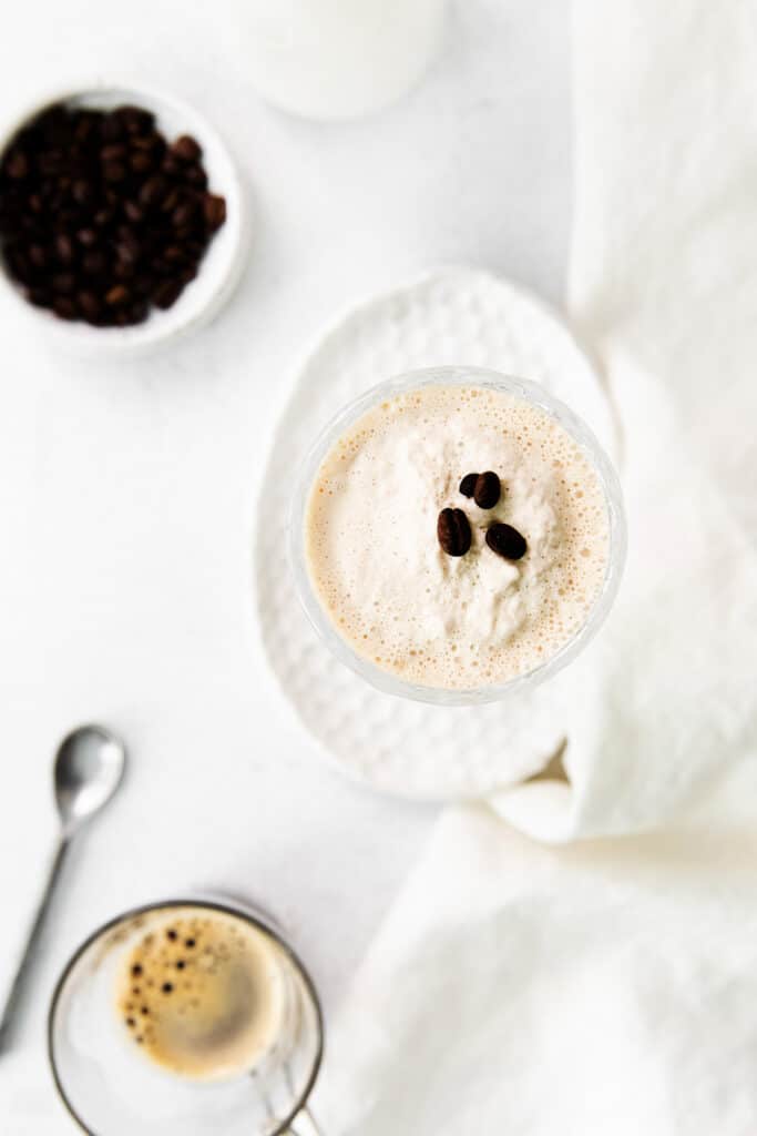 closeup of top of milkshake topped with coffee beans