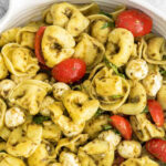 closeup of tortellini pasta salad in a big white bowl