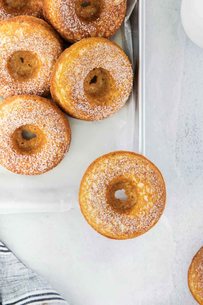 closeup of baked donuts on a baking sheet