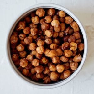 bowlful of pumpkin spice roasted chickpeas on a white table