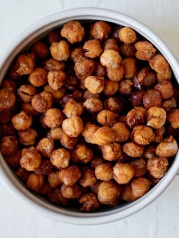 bowlful of pumpkin spice roasted chickpeas on a white table