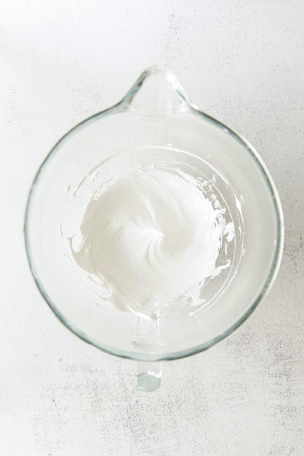glass mixing bowl with fluffy egg whites