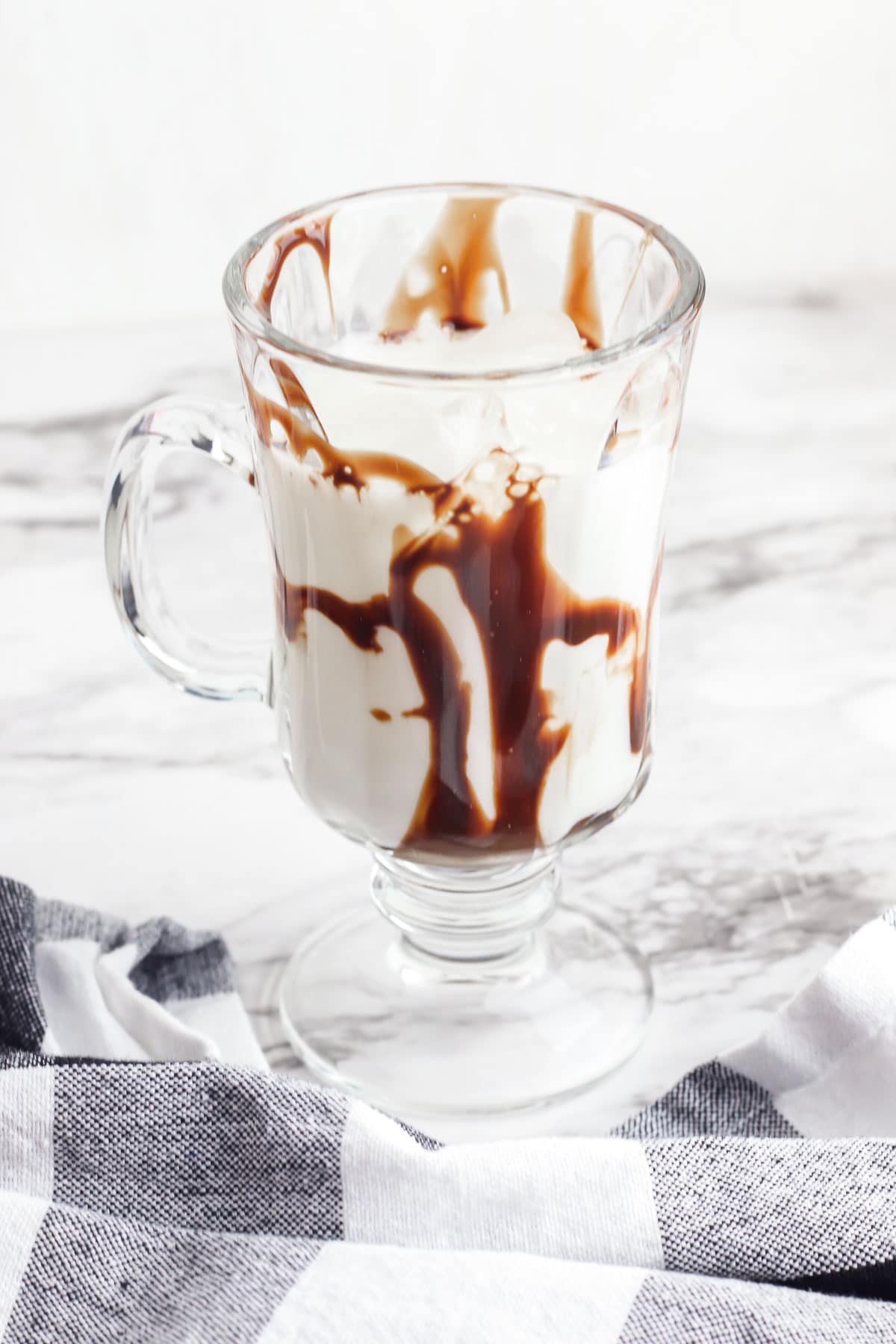 stemmed glass with a handle with milk and chocolate syrup