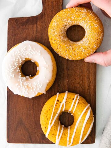 three vanilla glazed pumpkin donuts