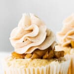 closeup of cupcake with apple pie filling and vanilla buttercream frosting