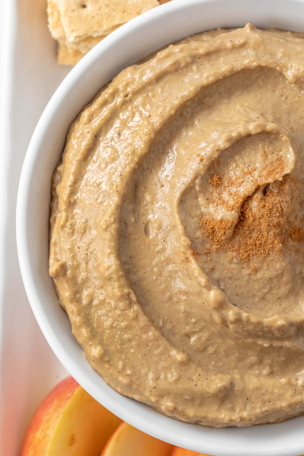 closeup of half a bowl of hummus topped with a spice