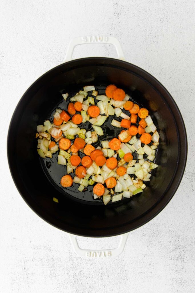 diced carrots, celery and onions in a black dutch pot