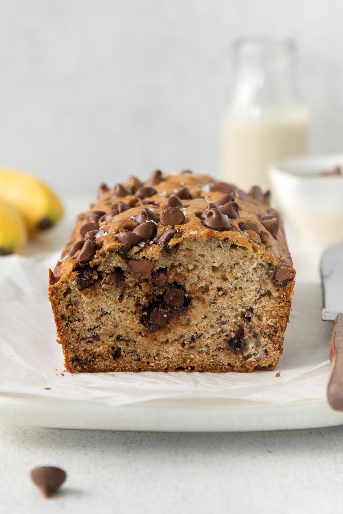 loaf of chocolate chip banana bread with a slice cut out showing the inside