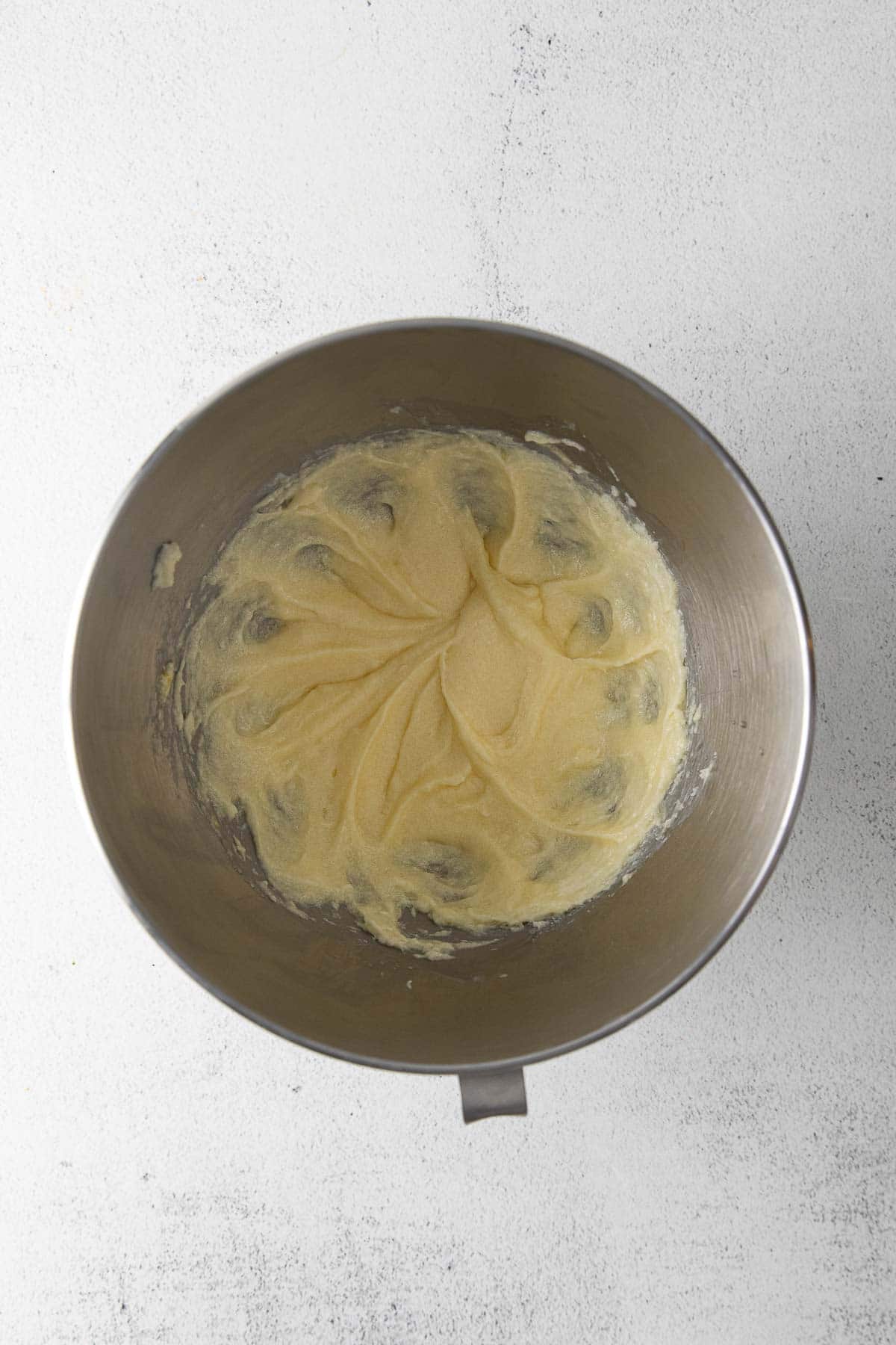 creamed butter in a stainless steel mixing bowl