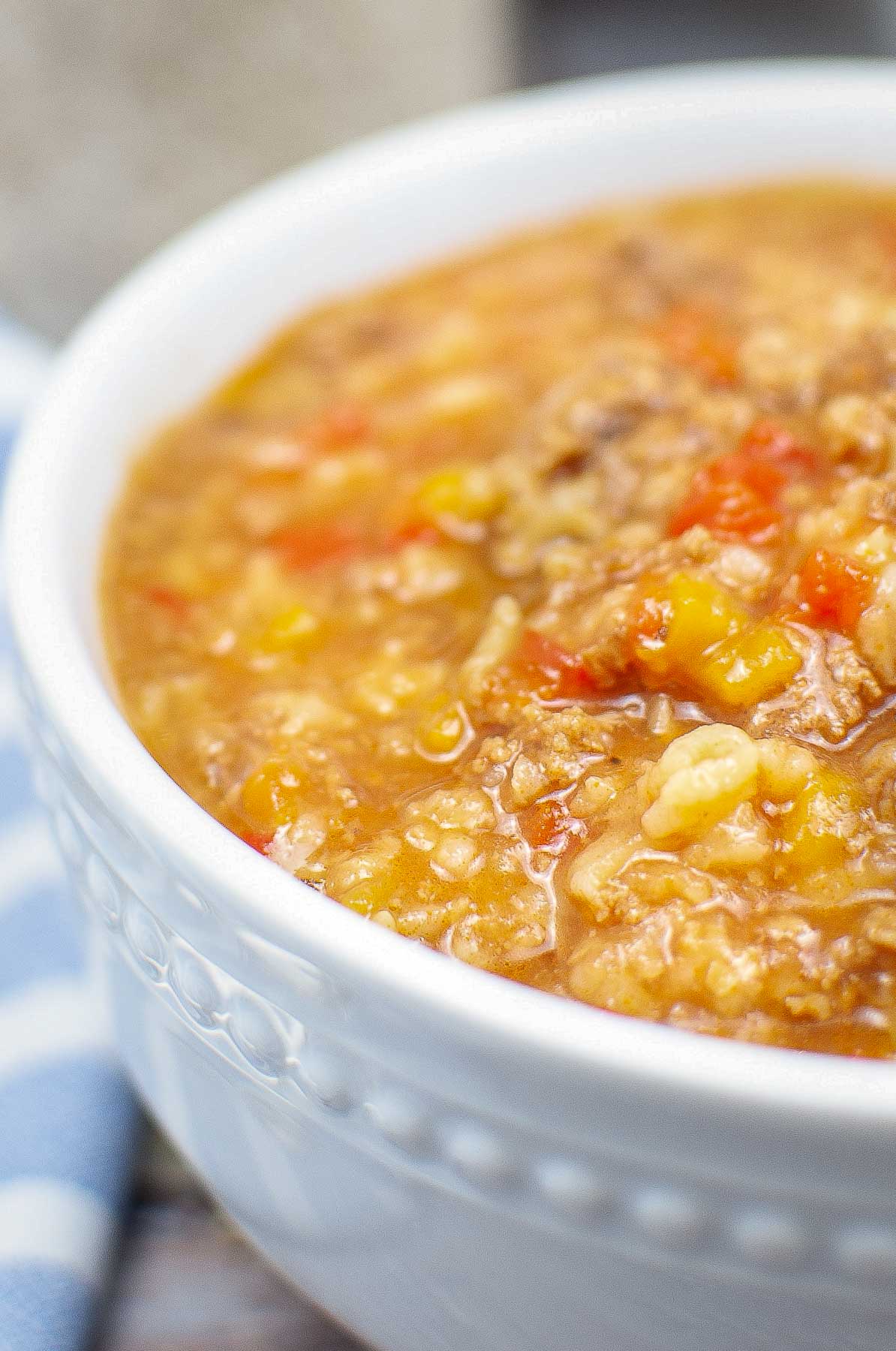 closeup of a white bowl with stuffed pepper soup with rice
