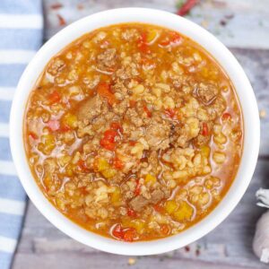 white bowl with stuffed pepper soup with rice and ground turkey