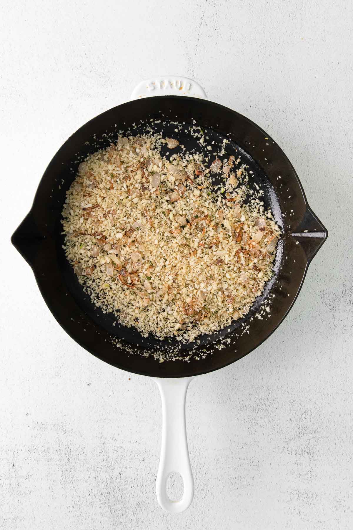 cast iron pan with browned panko breadcrumbs