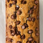 loaf of chocolate chip banana bread on white parchment paper
