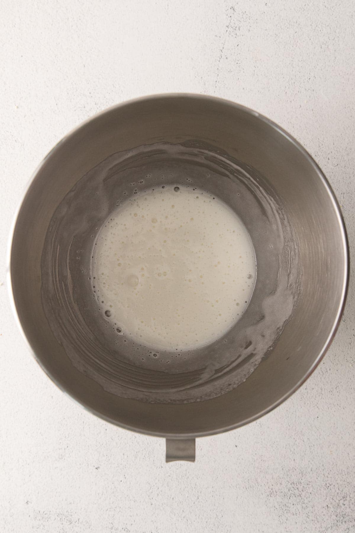 silver mixing bowl with egg white and sugar mixture