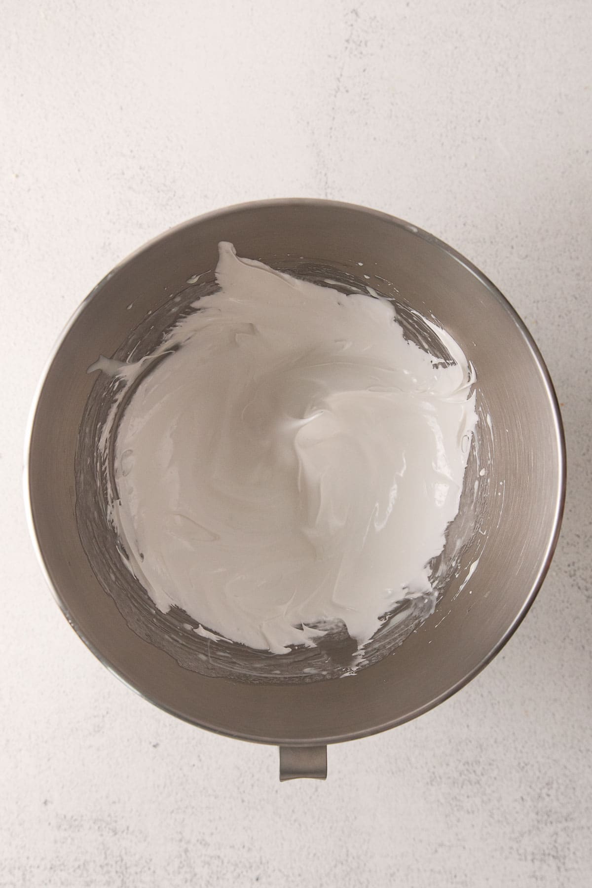 white mixing bowl with marshmallow cream peaks