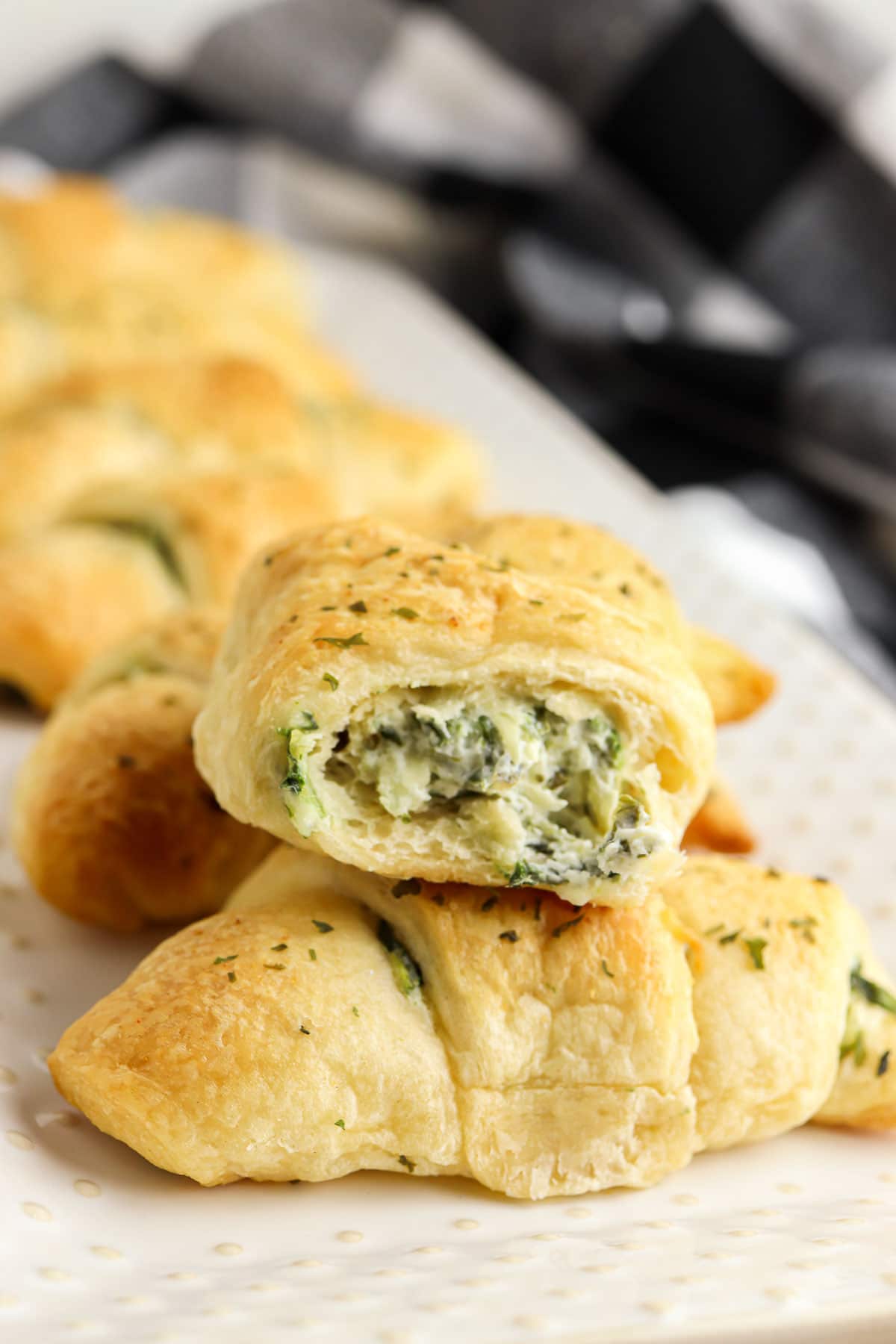 closeup of cut crescent roll filled with spinach artichoke mixture