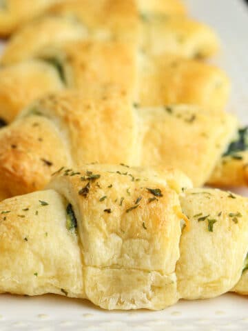 golden brown crescent roll topped with dried parsley