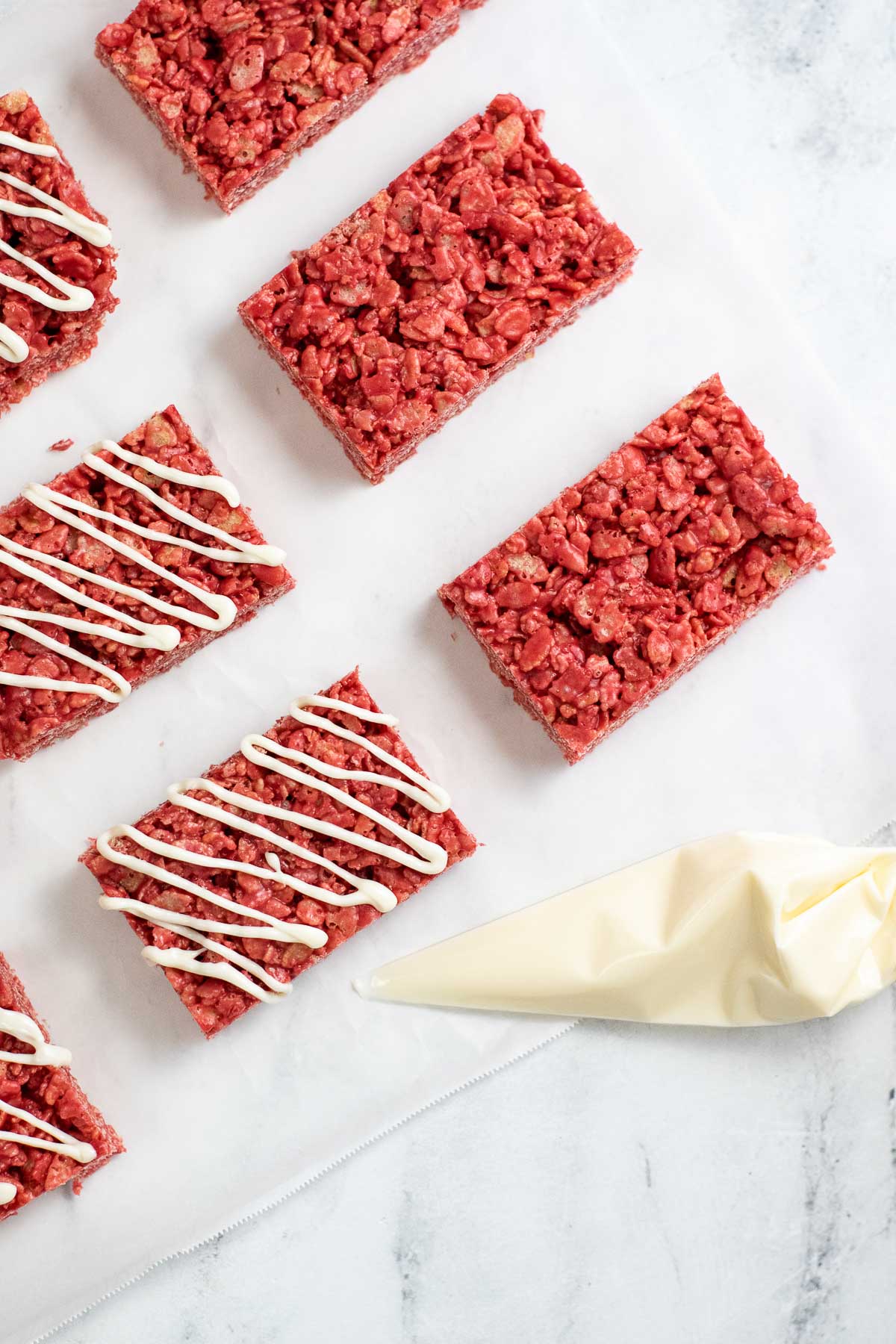 rectangle red valentine rice treats with white chocolate drizzle on top