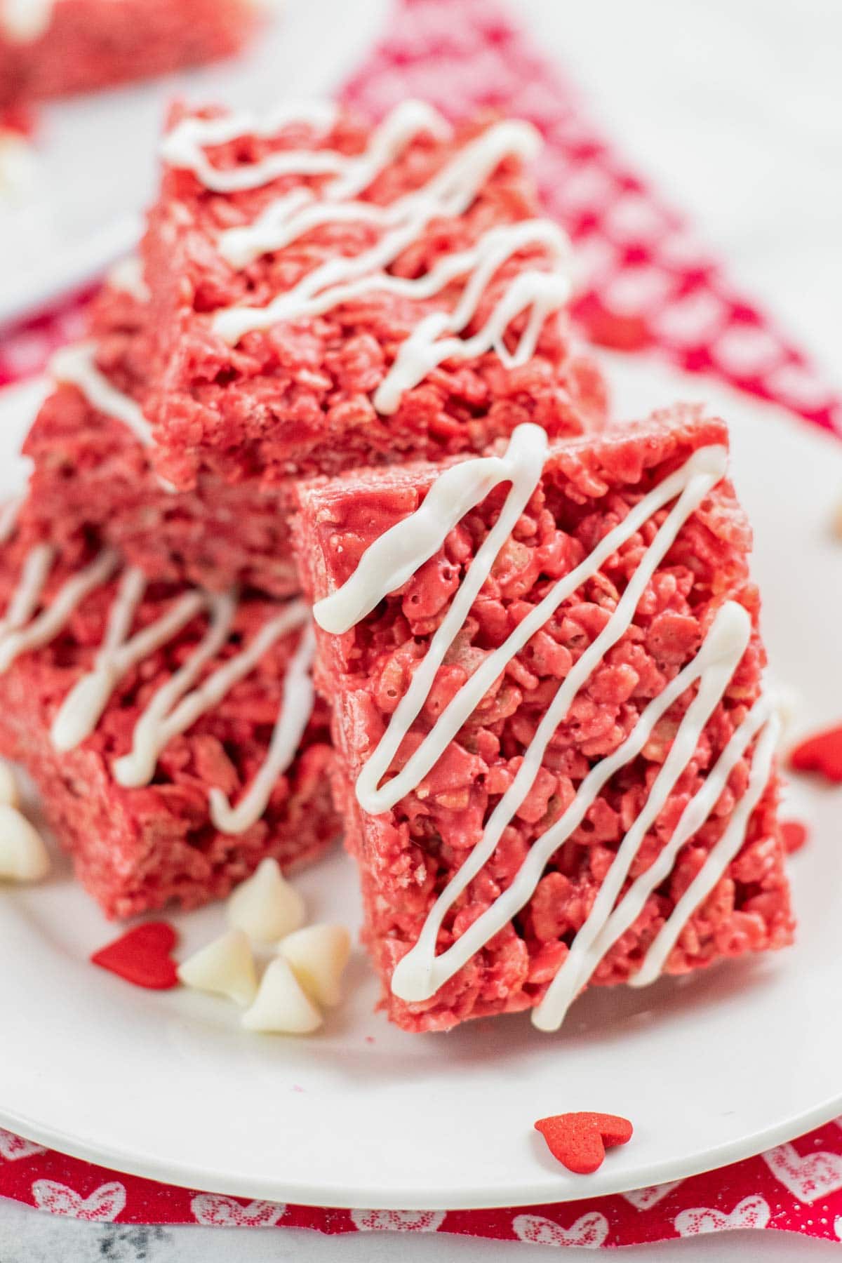 closeup of a valentine's decorated red rice krispie treat on a white plate
