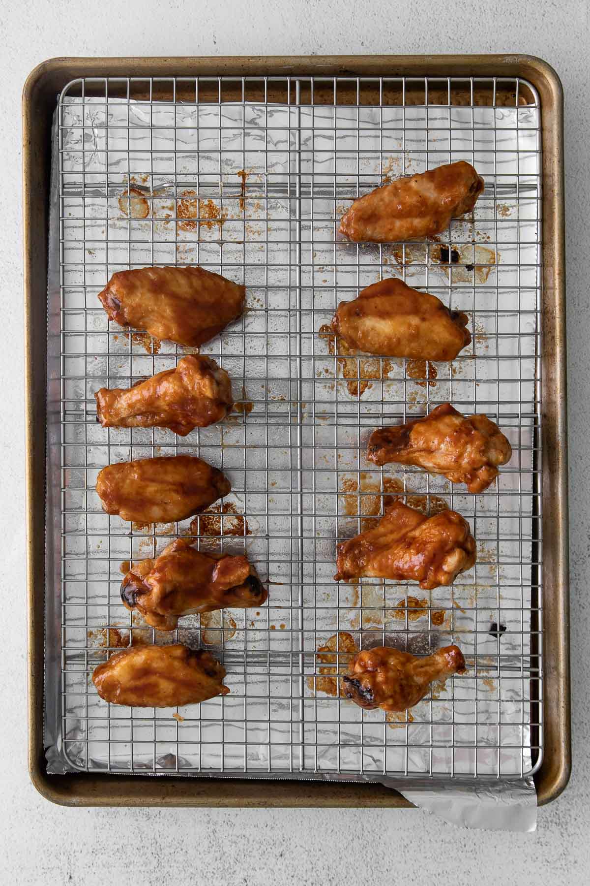 baked chicken wings on a wire rack lined baking sheet