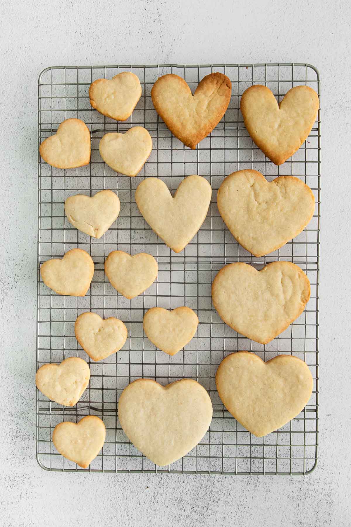 several heart shaped cookies on a wire rack
