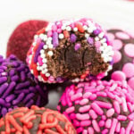 closeup of several brownie truffles coated in candy sprinkles