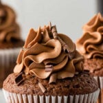 closeup of chocolate guinness cupcake with chocolate frosting and text overlay that reads Guinness Chocolate Cupcakes