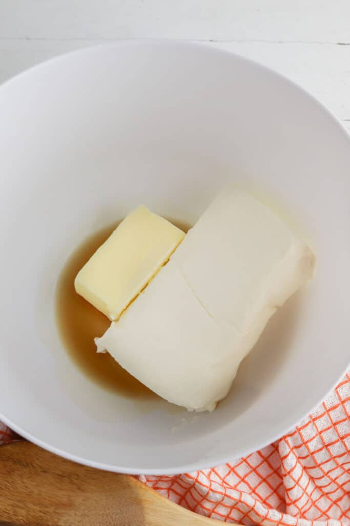 white mixing bowl with block of cream cheese and butter