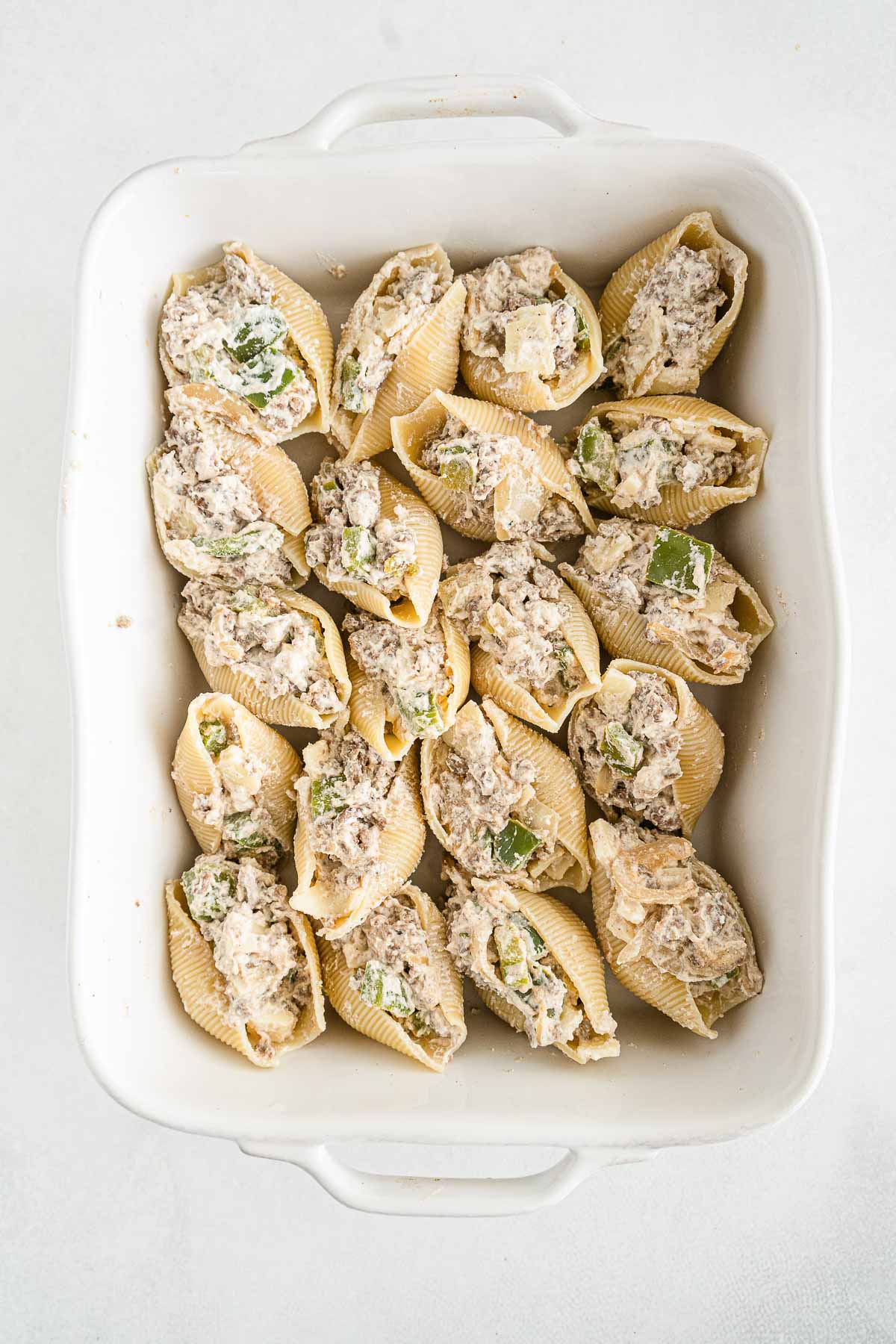 twenty stuffed pasta shells in a white casserole dish
