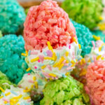 several pastel colored egg shaped rice krispie treats in a basket