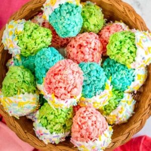 wood basket filled with egg shaped easter rice krispie treats