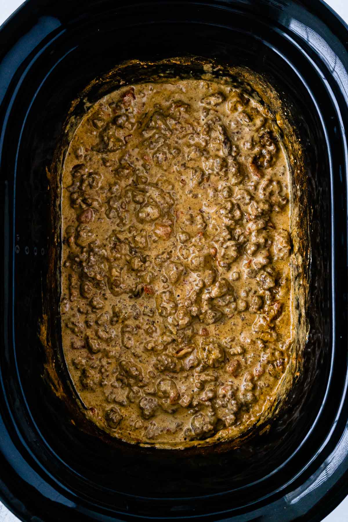 rotel dip with meat in a black slow cooker