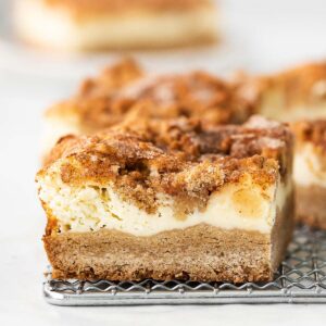 closeup of a snickerdoodle cheesecake bar on a small silver wire rack