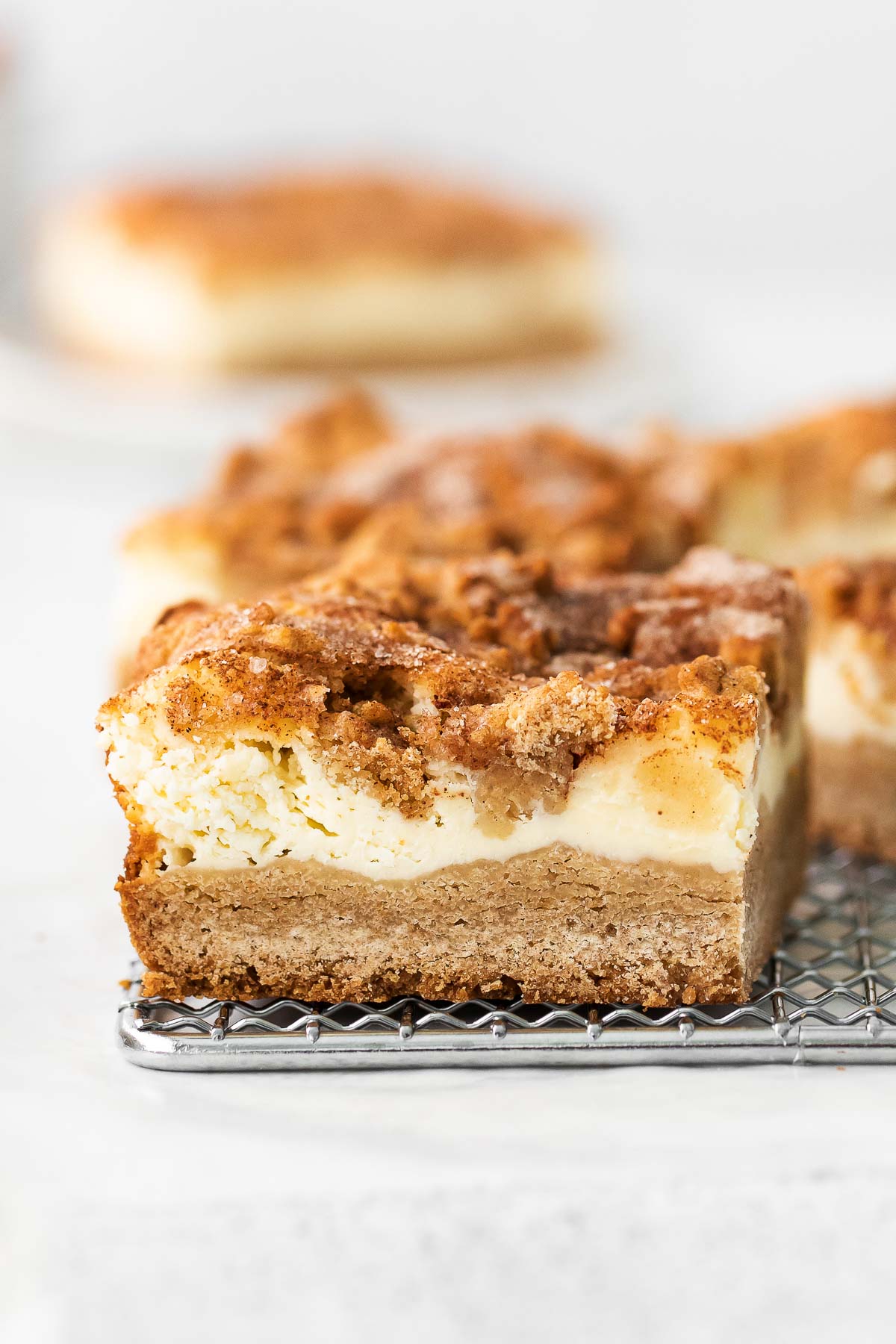 closeup of a cheesecake bar with snickerdoodle layer