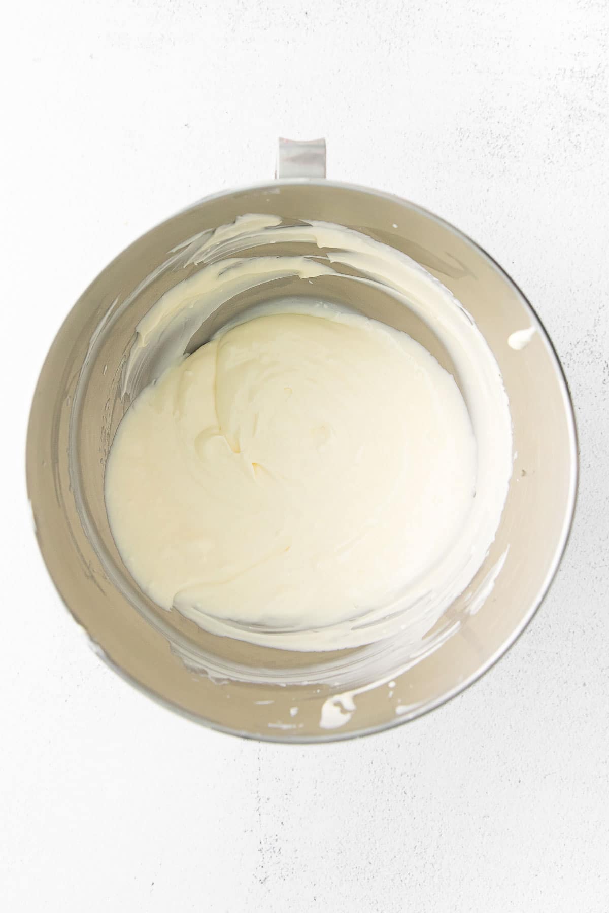 silver mixing bowl with blended cream cheese mixture