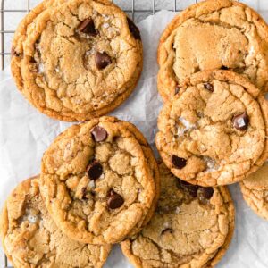 s'mores cookies with chocolate chips and marshmallows inside on white parchment paper