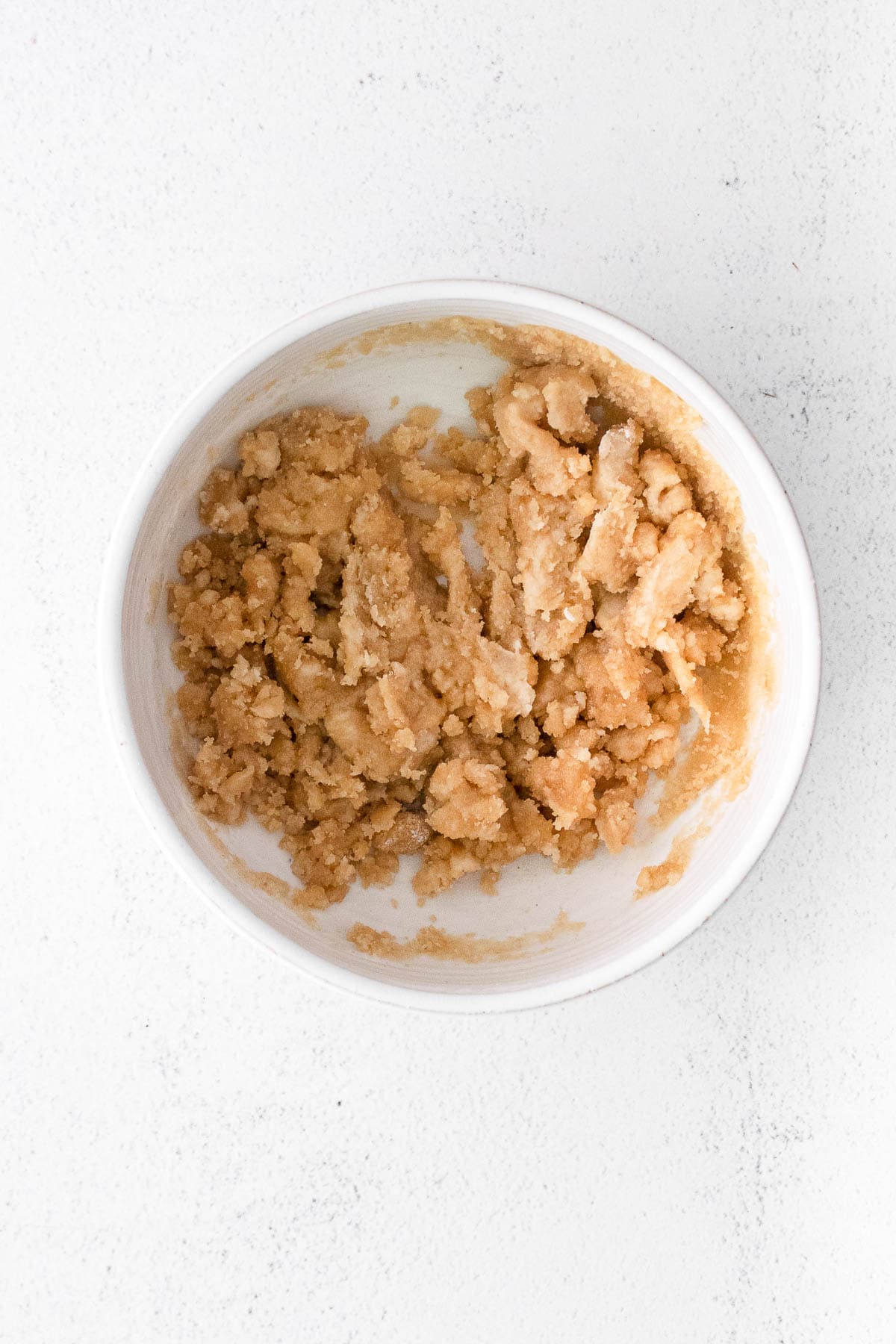 white bowl with streusel topping crumbles
