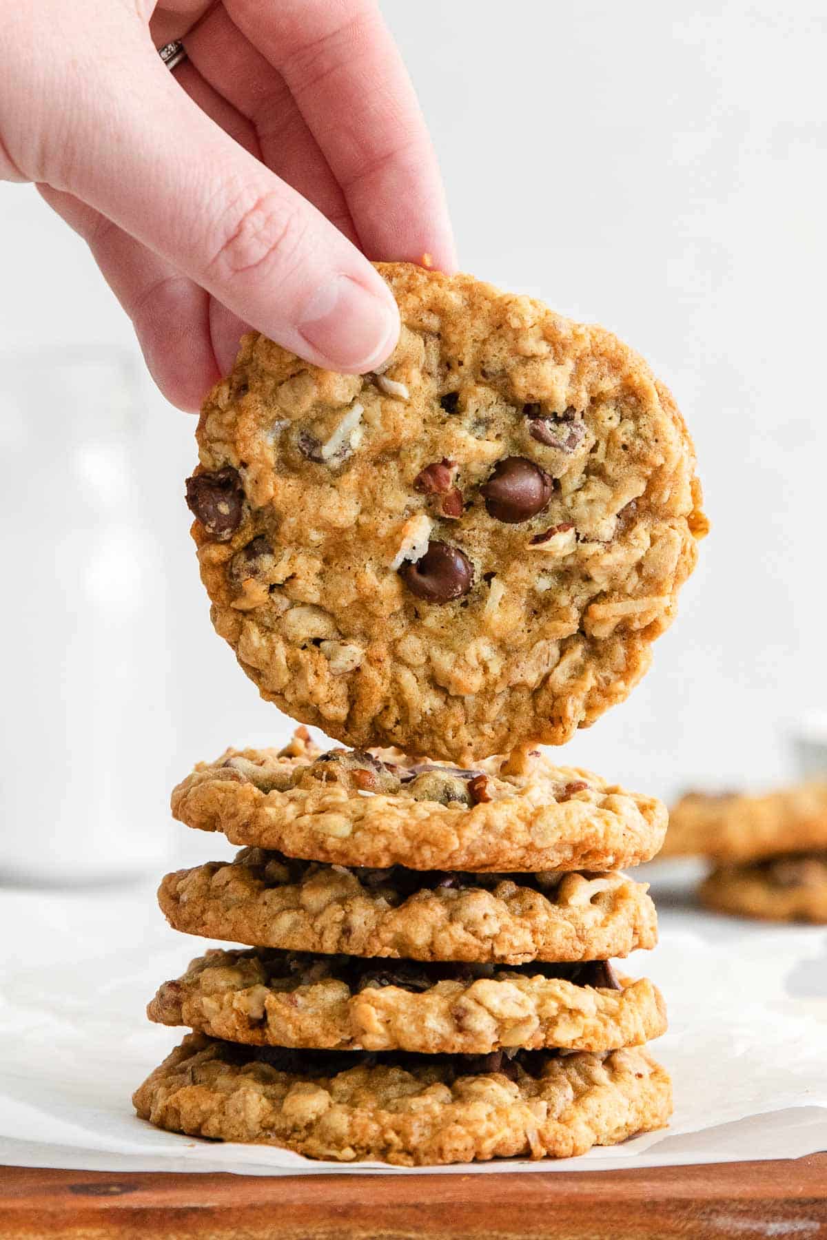 five cowboy cookies with oats, chocolate chips, chopped pecans and coconut
